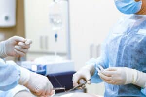 two surgeons finish up a procedure on a patient