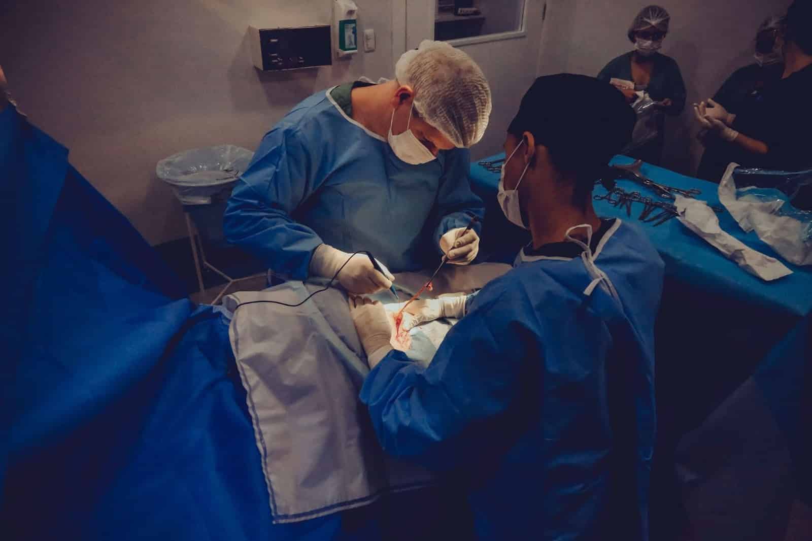 doctor performs surgery on a patient