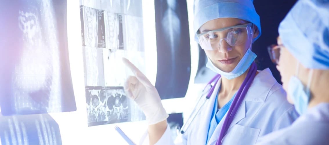Female physicians assess MRI scans from a patient