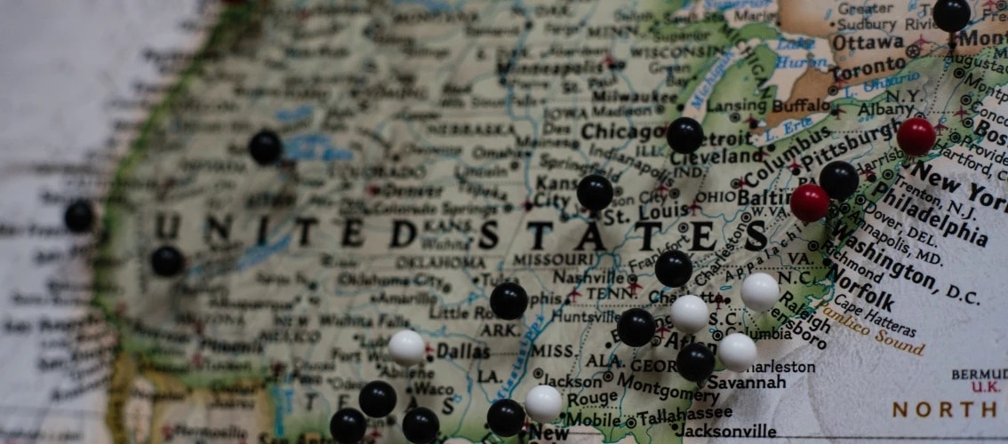 map of the United States with colored pins stuck in it