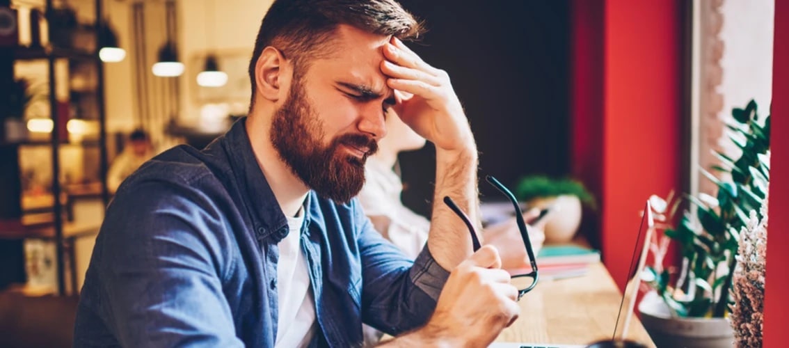 A male physician struggles to understand whats on his computer.