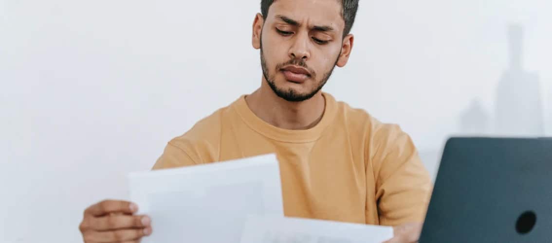 Male resident physician reviews paperwork.