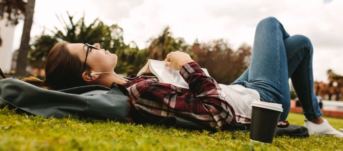 medical student lays in the park and relaxes