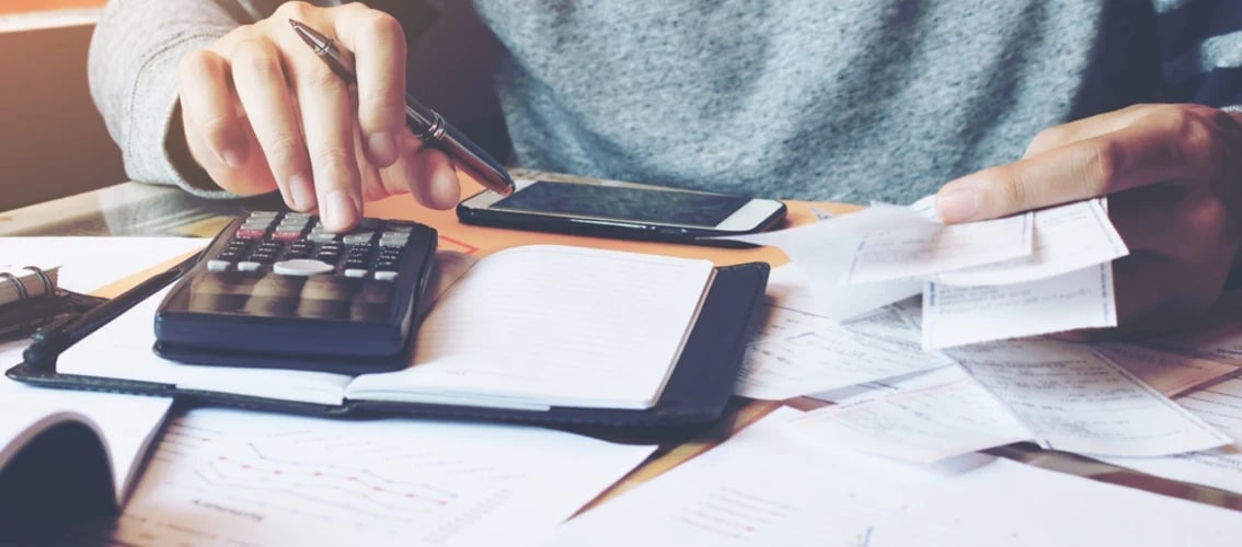 Doctor at a desk works on their personal budget