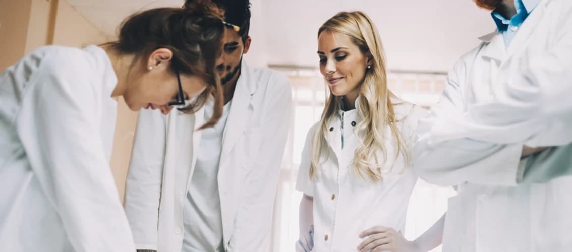 A group of medical residents reviews test results.