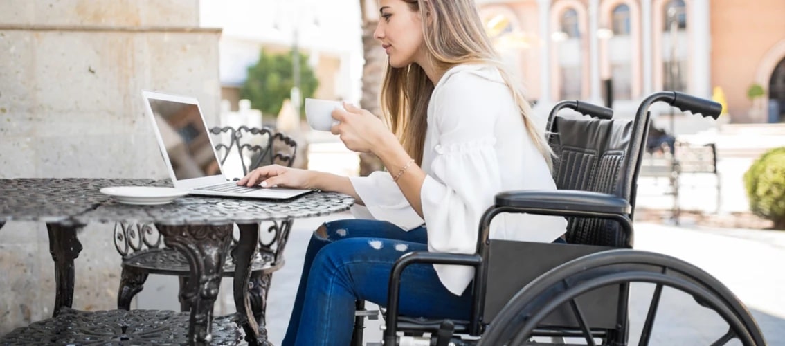 Female physician in a wheelchair looking at laptop