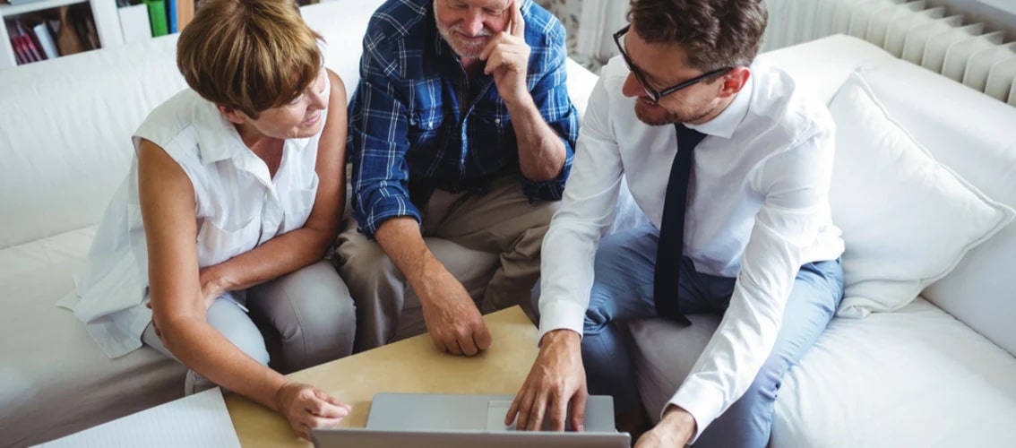 An older couple discusses a trust with an advisor
