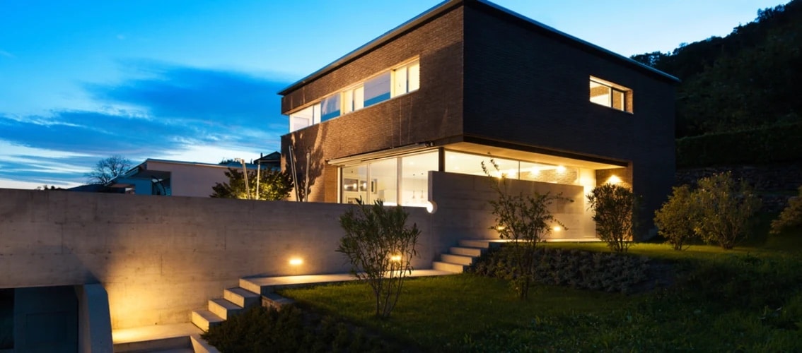 large modern home with steps at sunset