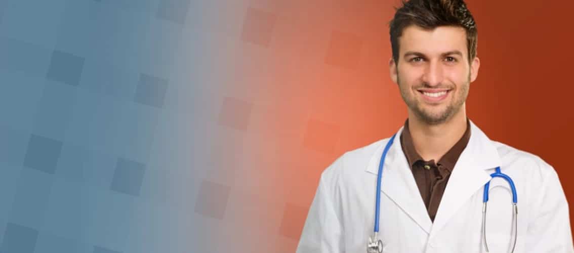 Male physician in a white coat smiling.