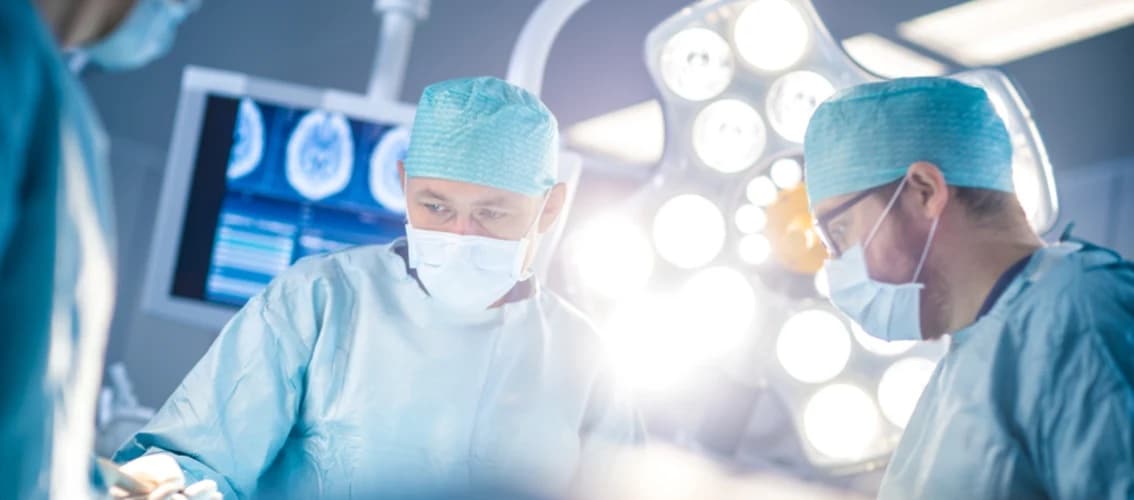 Surgeons in an operating room with bright light