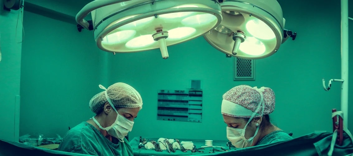 Two doctors prepare for a procedure.