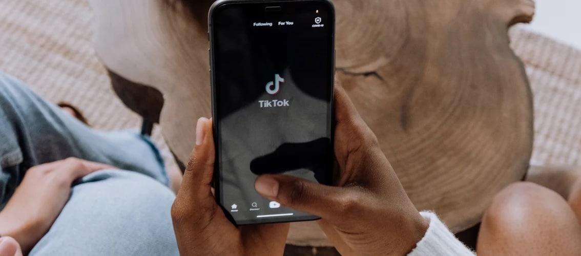 view of hands holding a phone with tiktok app