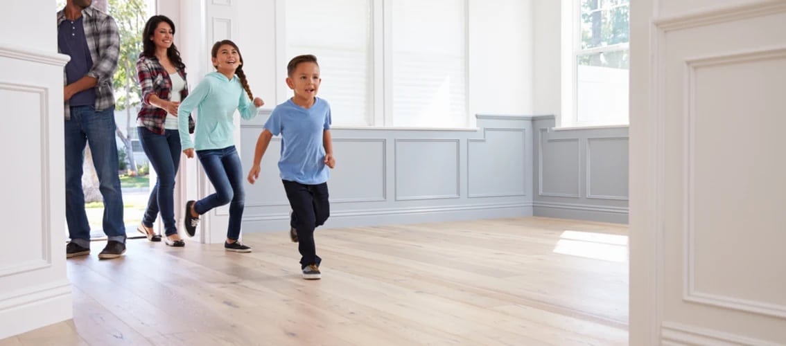 happy family walks in the door of a new home