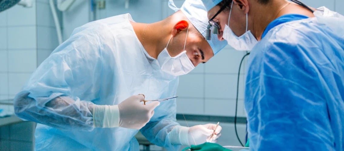 A surgeon operates on a patient in a hospital