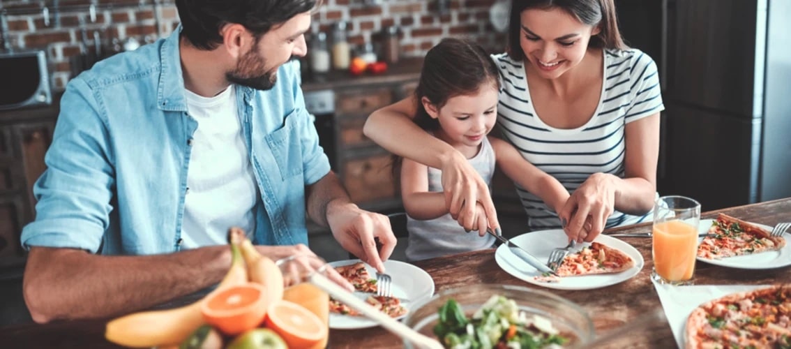 doctor couple at home eating with child
