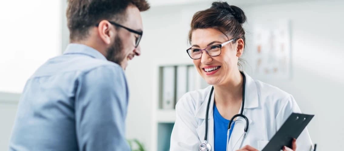 A female physician and her coach laughing