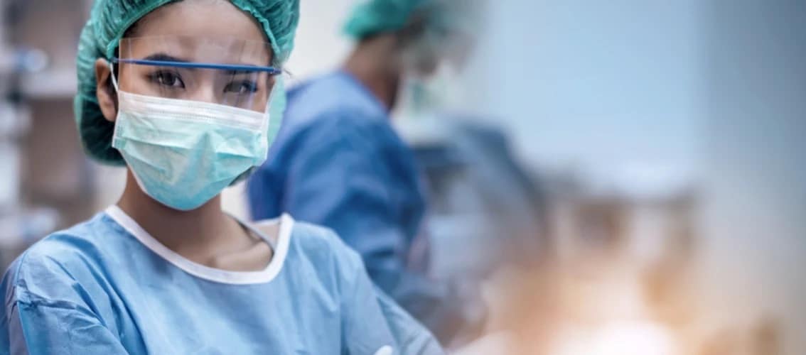 A female physician wears ppe in a hospital