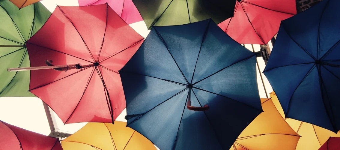 Upward view of multiple open umbrellas