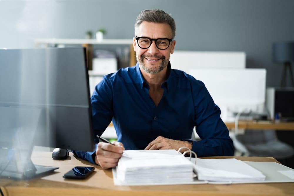 An accountant sits at his desk