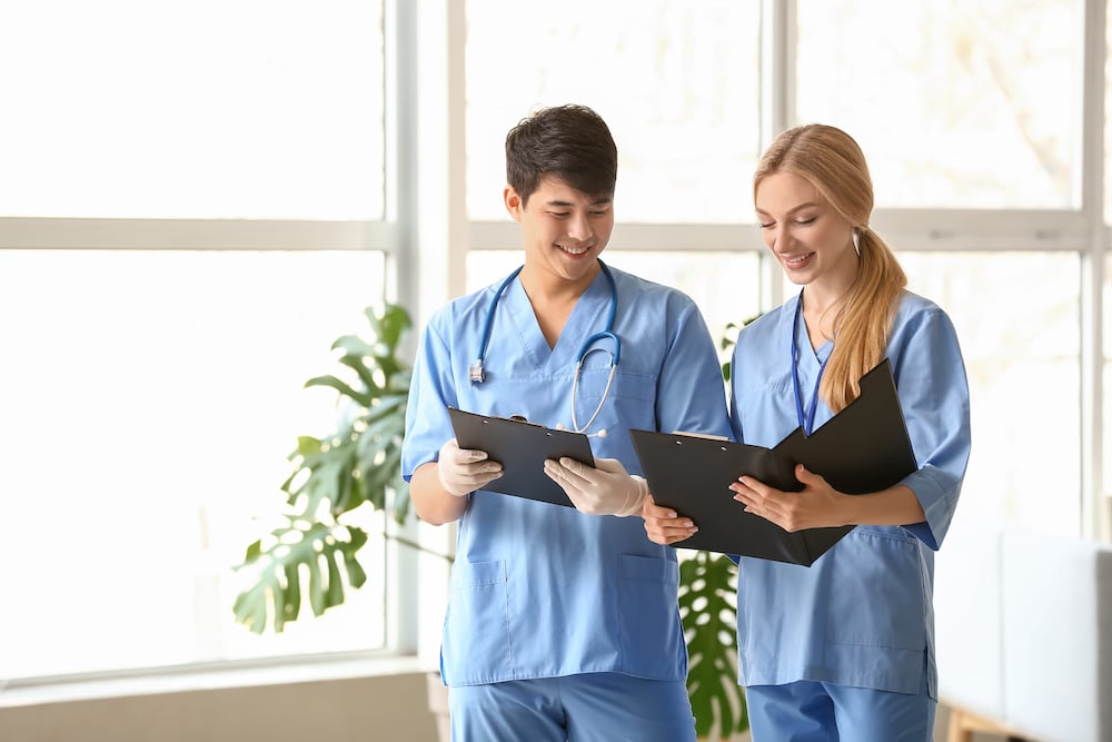Two medical fellows look at salary documents
