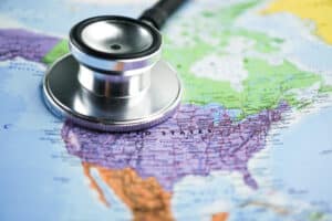 A stethoscope sits on top of a map of the USA.