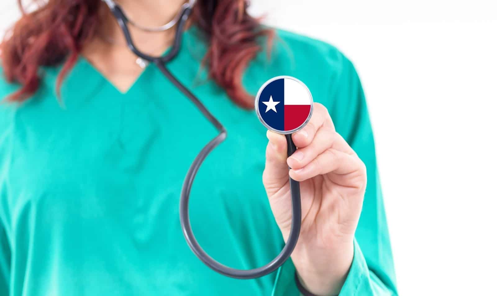 Female physician with a Texas flag stethoscope