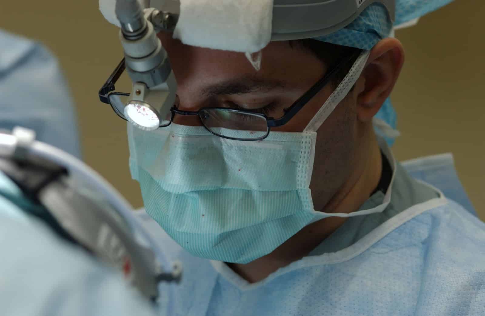 A resident doctor performs surgery