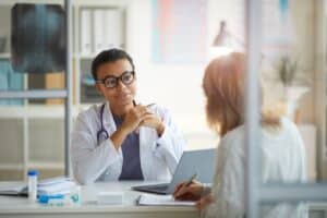 Physician smiling with consulting expert