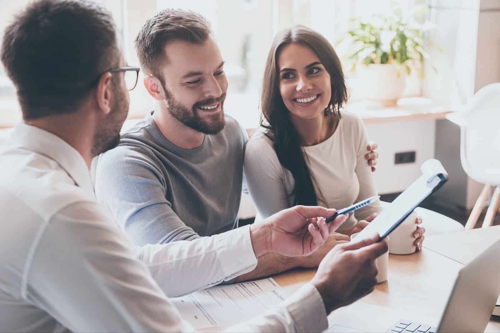 Physician and wife discussing a mortgage with specialist