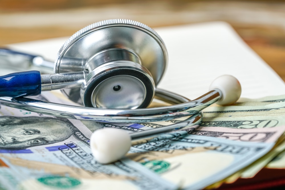 a stethoscope on top of a pile of money