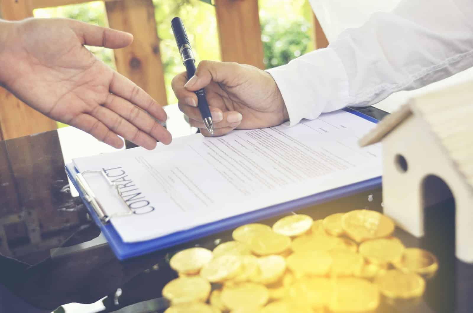 A doctor holds a pen and reviews a contract