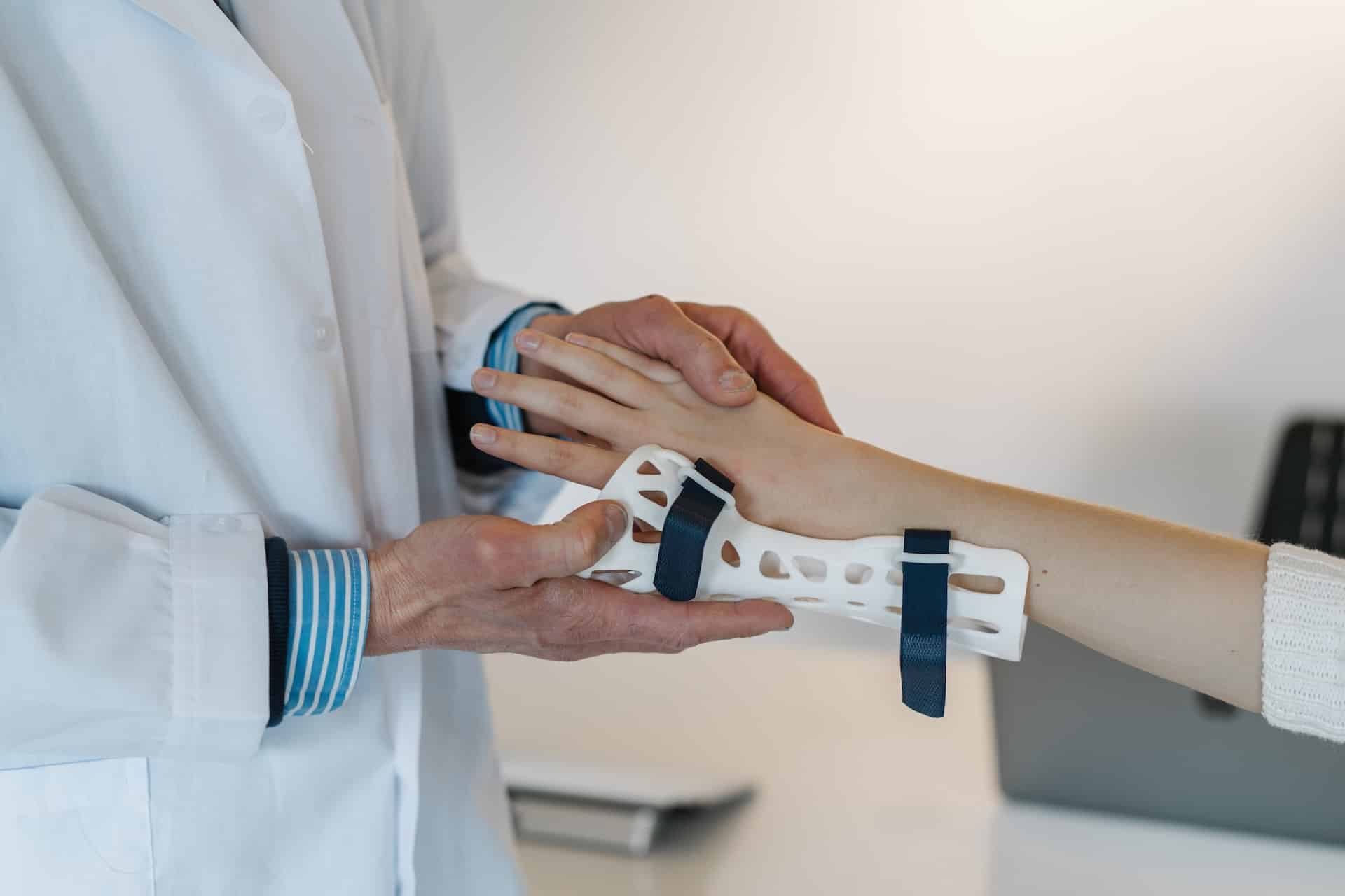 doctor putting a brace on patient's wrist