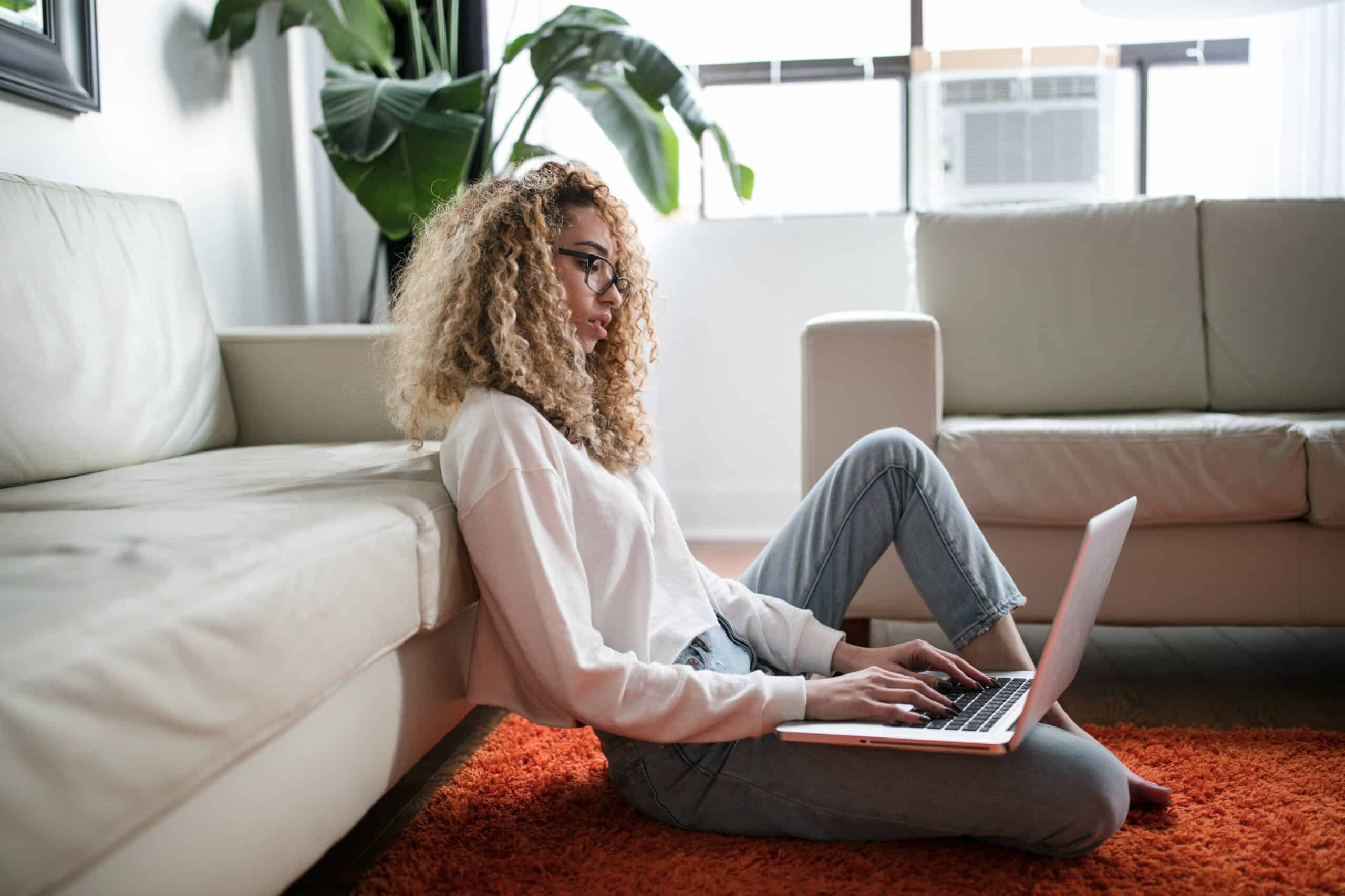 Female doctor works on her computer while sitting at home
