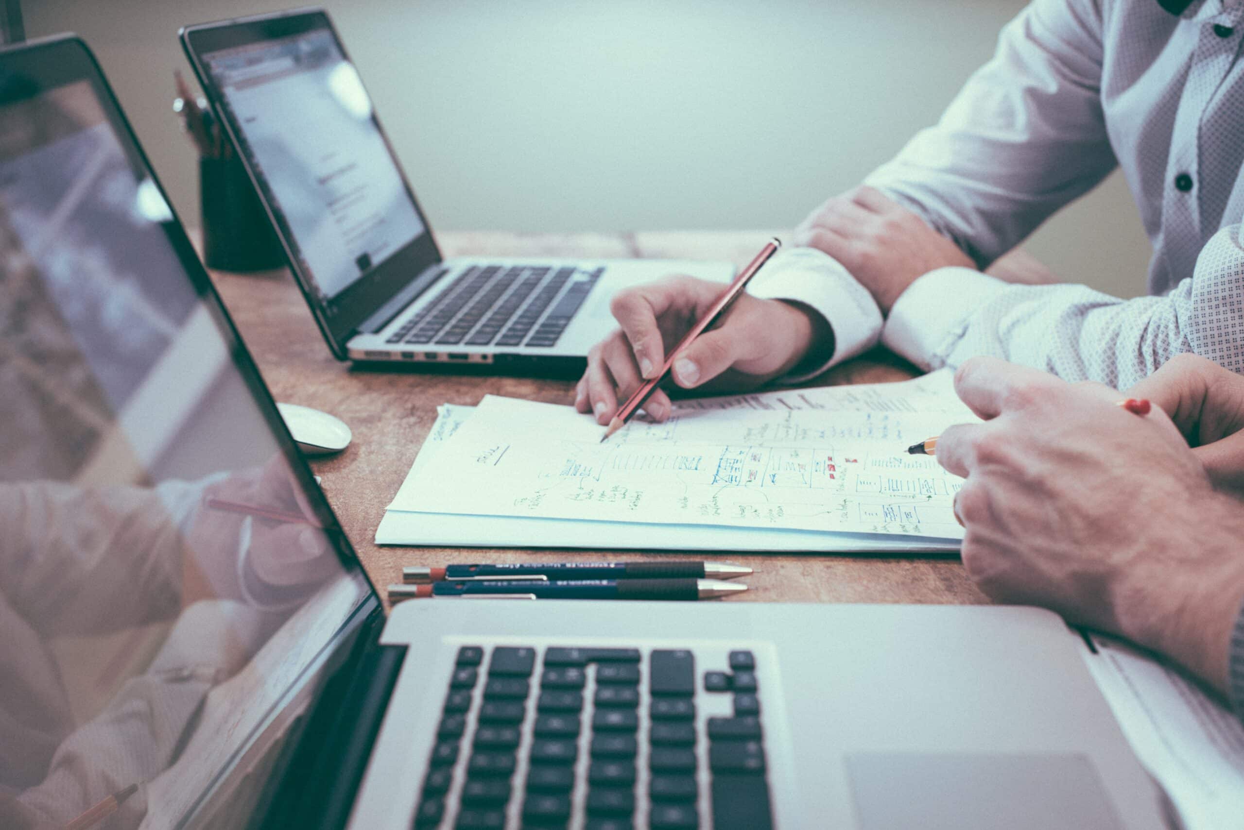 Doctors look at their computers and paperwork